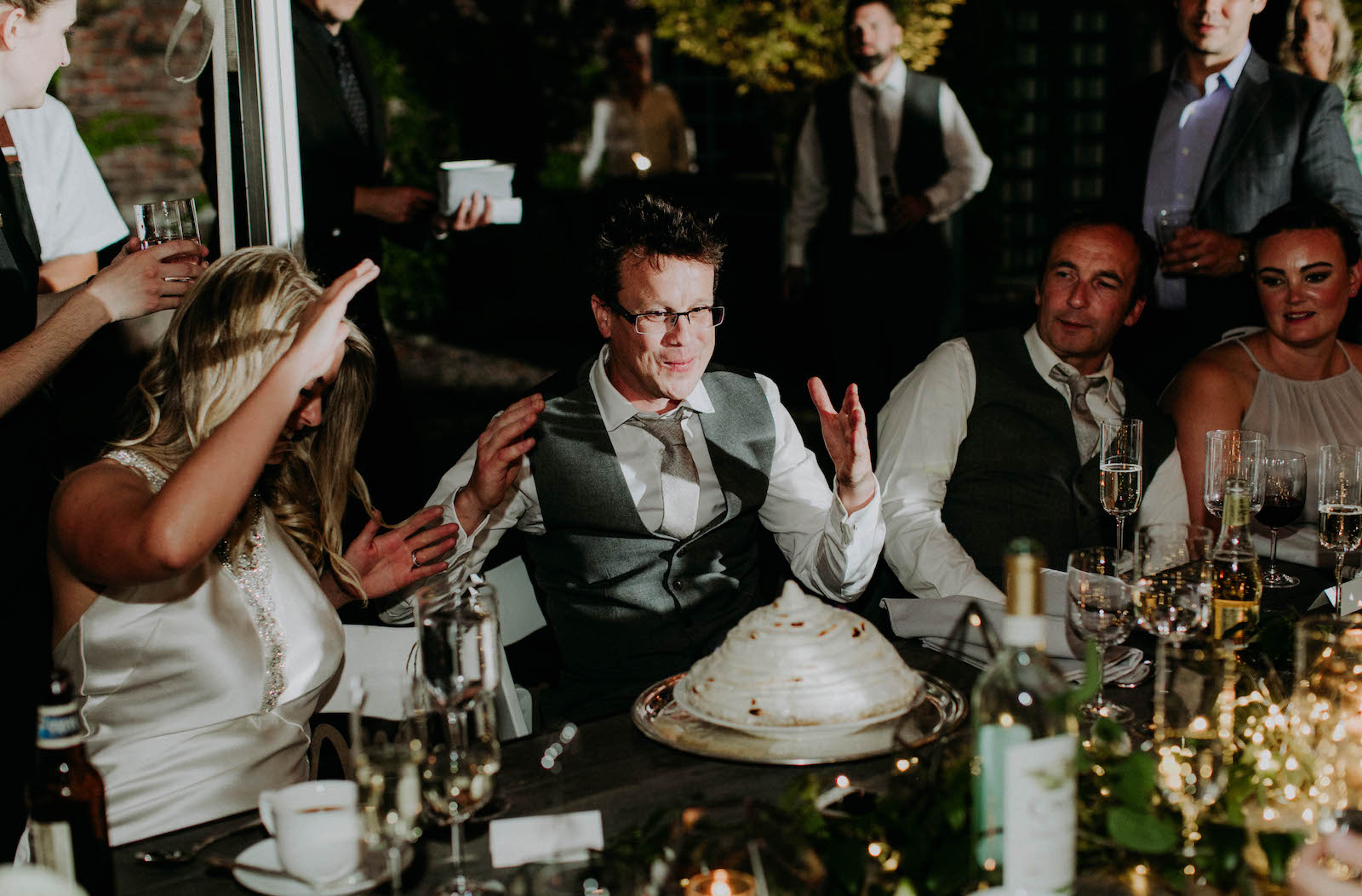 Wedding coule receiving their baked alaska cake to cut