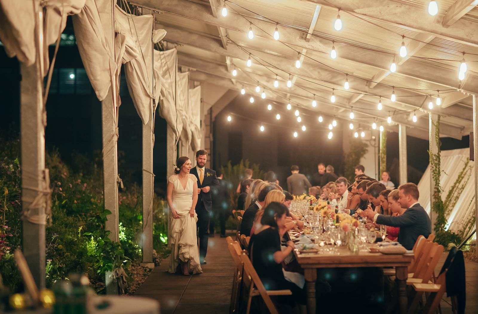 Bride & Groom saying hello to their guests around the tables
at The Brooklyn Grange farm in the Brooklyn Navy Yard.